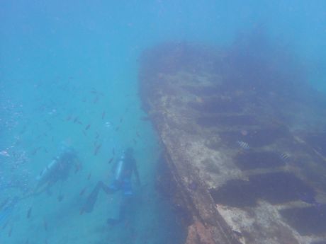 scuba divers prepare to explore a wreck dive site in the Caribbean